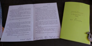 The chapbook mock-up (on the right), with a sample imposition page with notes for various pdf and printer adjustments. (The dragon is just being a paperweight.)
